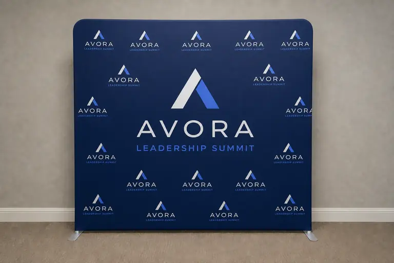 Sample Avora leadership summit backdrop concept with a navy and cobalt step-and-repeat logo pattern