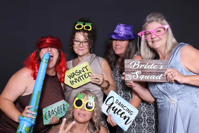 Guests enjoying a photo booth with a dark backdrop, photo 4