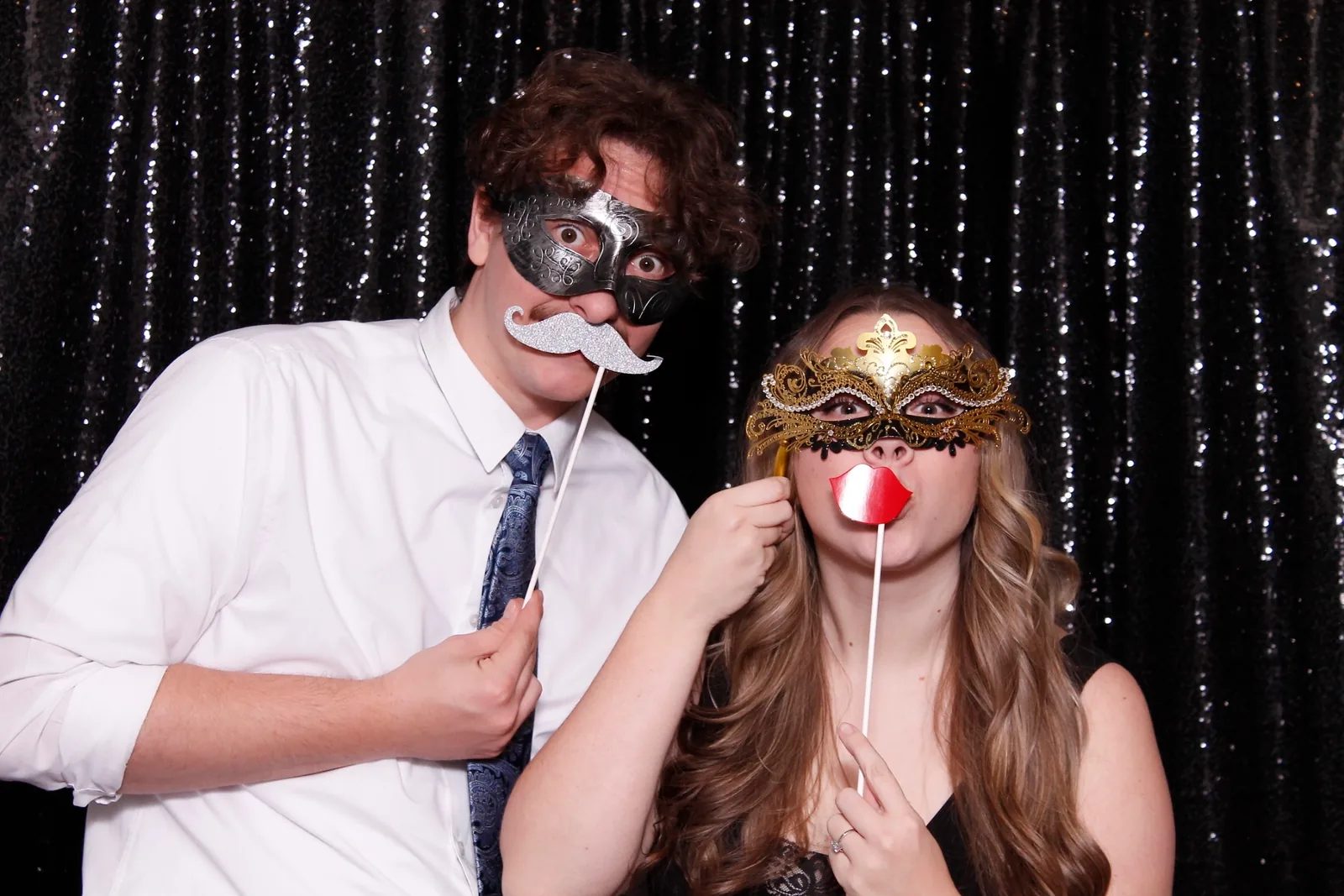 Guests enjoying a photo booth with a dark backdrop, photo 7