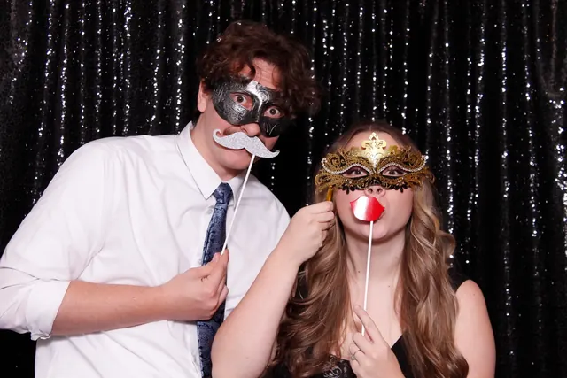 Guests enjoying a photo booth with a dark backdrop, photo 7
