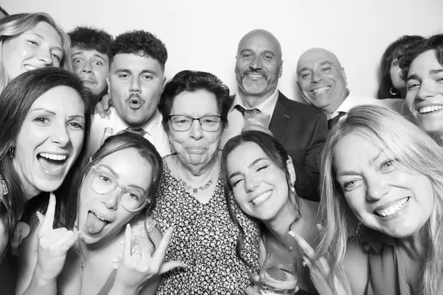 Guests posing for a polished black-and-white Glam Booth portrait, photo 14