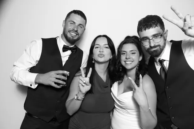 Guests posing for a polished black-and-white Glam Booth portrait, photo 15