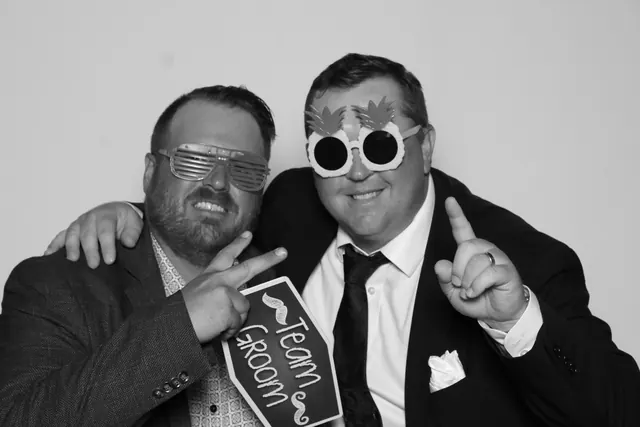 Guests posing for a polished black-and-white Glam Booth portrait, photo 25