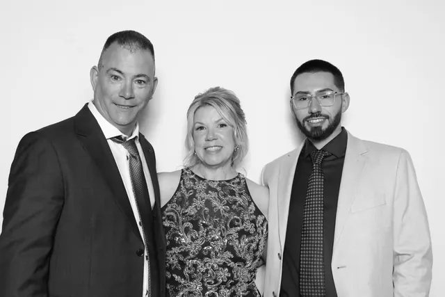 Guests posing for a polished black-and-white Glam Booth portrait, photo 26