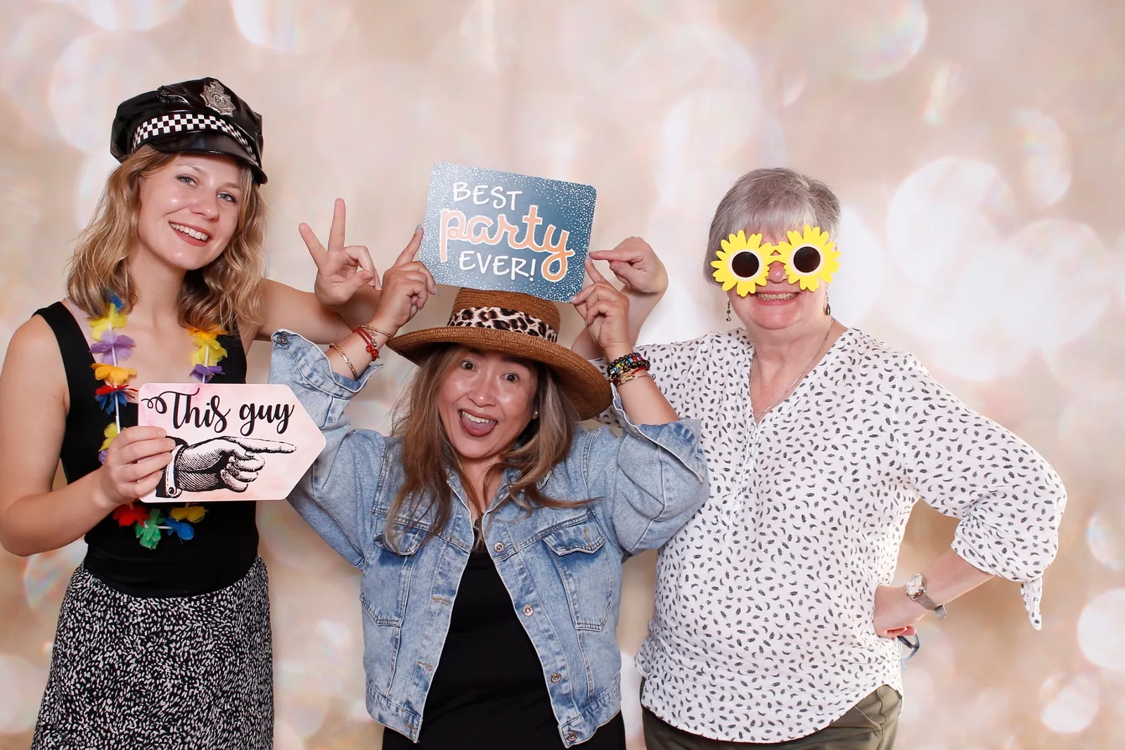 Guests enjoying a photo booth with a champagne backdrop, photo 1