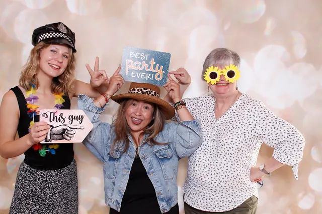 Guests enjoying a photo booth with a champagne backdrop, photo 1