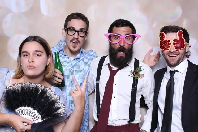 Guests enjoying a photo booth with a champagne backdrop, photo 2