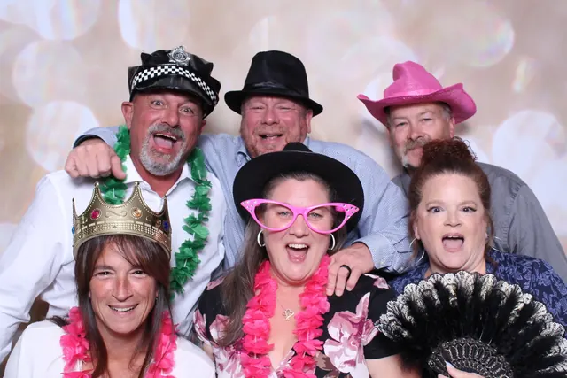 Guests enjoying a photo booth with a champagne backdrop, photo 3