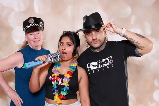 Guests enjoying a photo booth with a champagne backdrop, photo 7