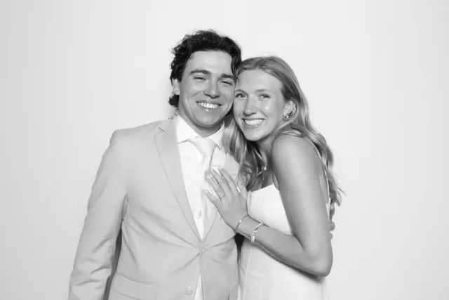Wedding couple smiling together in a black-and-white Glam photo booth portrait.