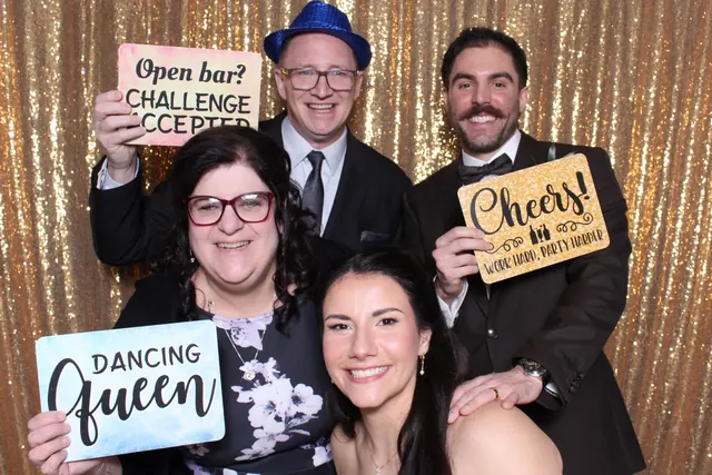 Guests enjoying a photo booth with a gold sequin backdrop, photo 7