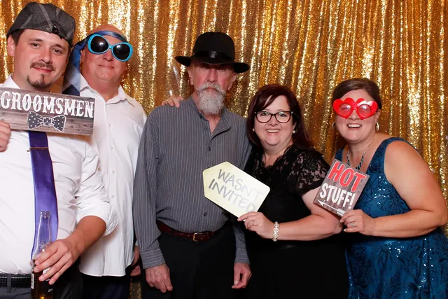 Guests enjoying a photo booth with a gold sequin backdrop, photo 10
