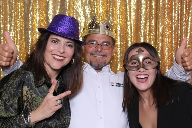Guests enjoying a photo booth with a gold sequin backdrop, photo 14