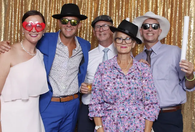 Guests enjoying a photo booth with a gold sequin backdrop, photo 15