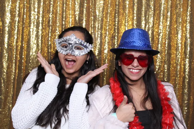 Guests enjoying a photo booth with a gold sequin backdrop, photo 22
