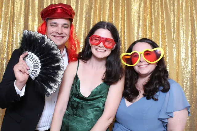 Guests enjoying a photo booth with a gold sequin backdrop, photo 25