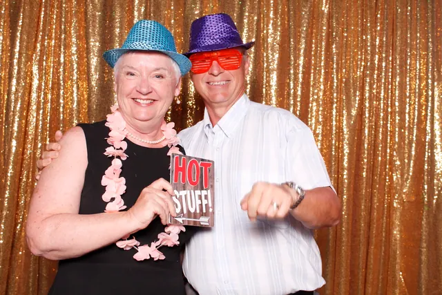 Guests enjoying a photo booth with a gold sequin backdrop, photo 27