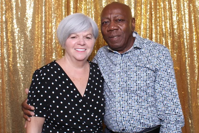 Guests enjoying a photo booth with a gold sequin backdrop, photo 29