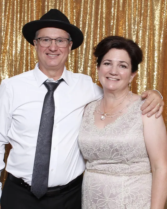 Guests enjoying a photo booth with a gold sequin backdrop, photo 30