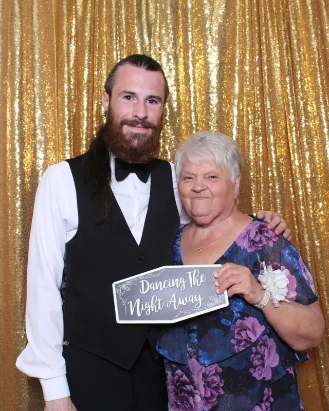 Guests enjoying a photo booth with a gold sequin backdrop, photo 33