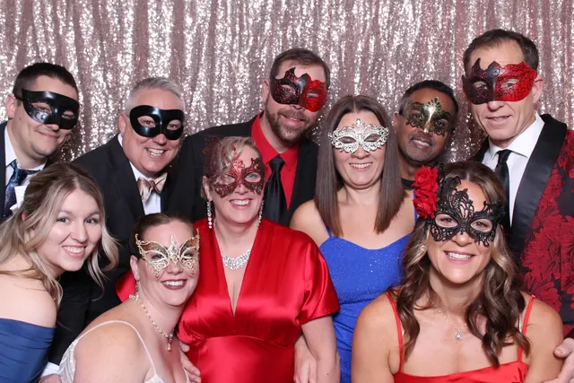 Guests enjoying a photo booth with a rose-gold sequin backdrop, photo 3