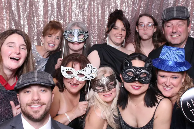 Guests enjoying a photo booth with a rose-gold sequin backdrop, photo 5