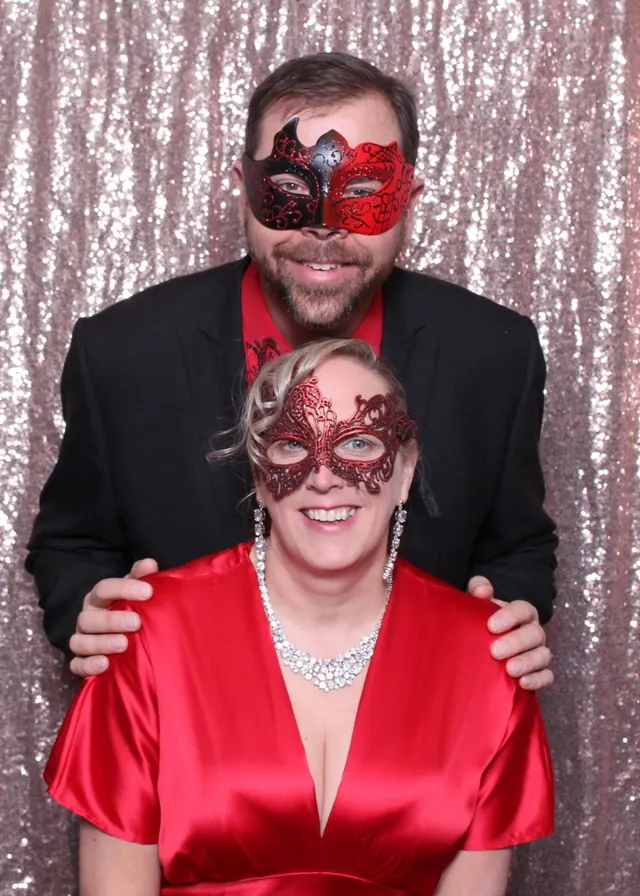 Guests enjoying a photo booth with a rose-gold sequin backdrop, photo 7