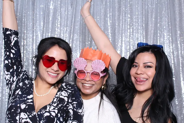 Guests enjoying a photo booth with a silver sequin backdrop, photo 6