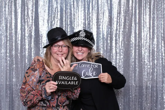 Guests enjoying a photo booth with a silver sequin backdrop, photo 7