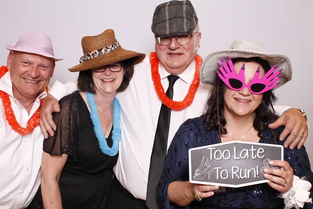 Guests enjoying a photo booth with a white neutral backdrop, photo 21