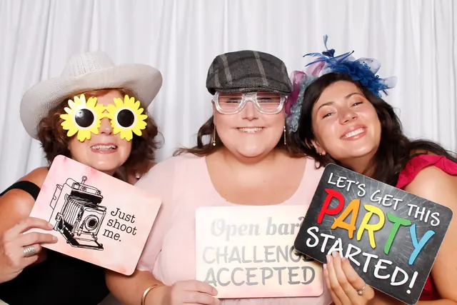 Guests enjoying a photo booth with a white neutral backdrop, photo 24