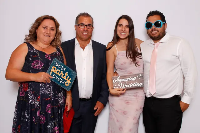 Guests enjoying a photo booth with a white neutral backdrop, photo 27