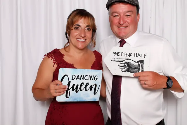Guests enjoying a photo booth with a white neutral backdrop, photo 28