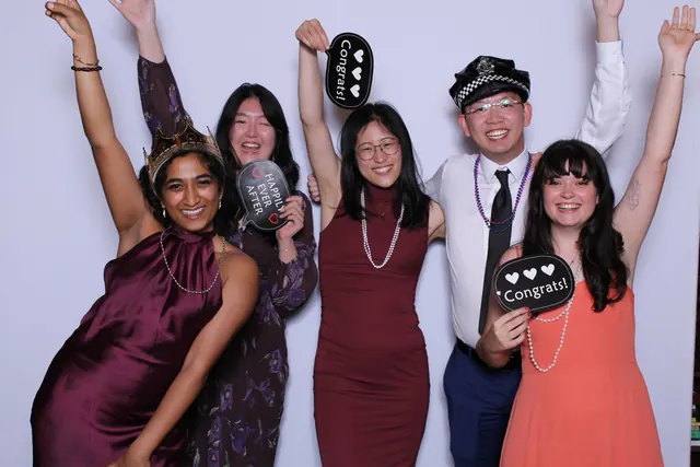 Guests enjoying a photo booth with a white neutral backdrop, photo 31