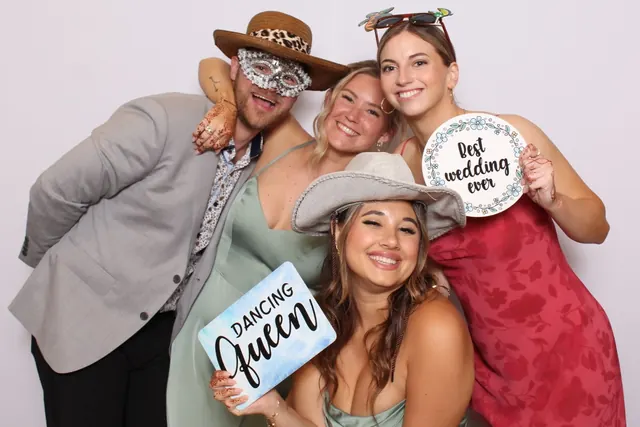 Guests enjoying a photo booth with a white neutral backdrop, photo 32