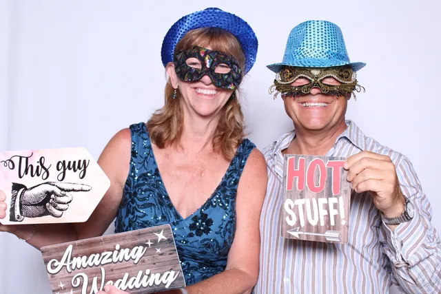 Guests enjoying a photo booth with a white neutral backdrop, photo 33
